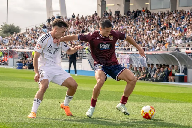 Dos jugadores de fútbol disputan el balón durante un partido